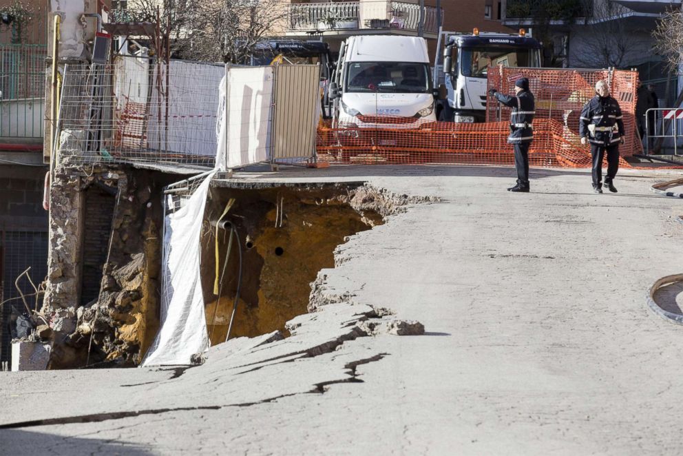 PHOTO: Policemen, firefighters and technicians work at the Via Livio Andronico to restore the road the day after a sinkhole that opened up in Rome, Feb. 15, 2018.