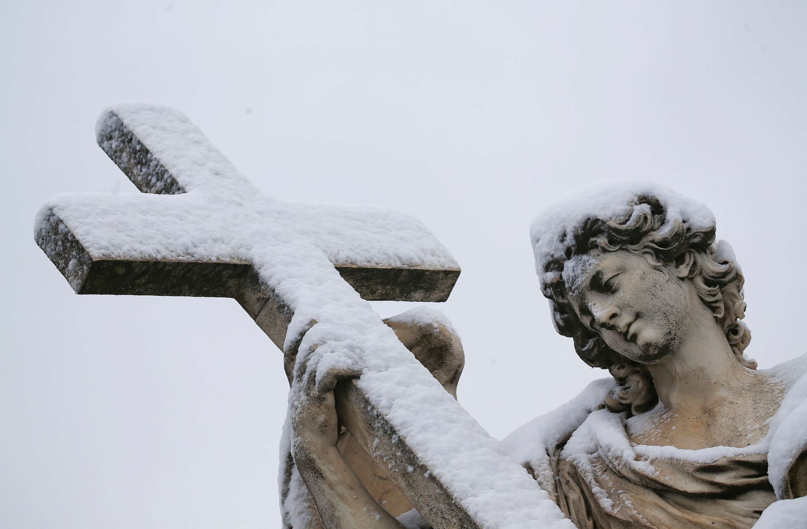 PHOTO: A statue is seen covered in snow during a heavy snowfall in Rome, Feb. 26, 2018.