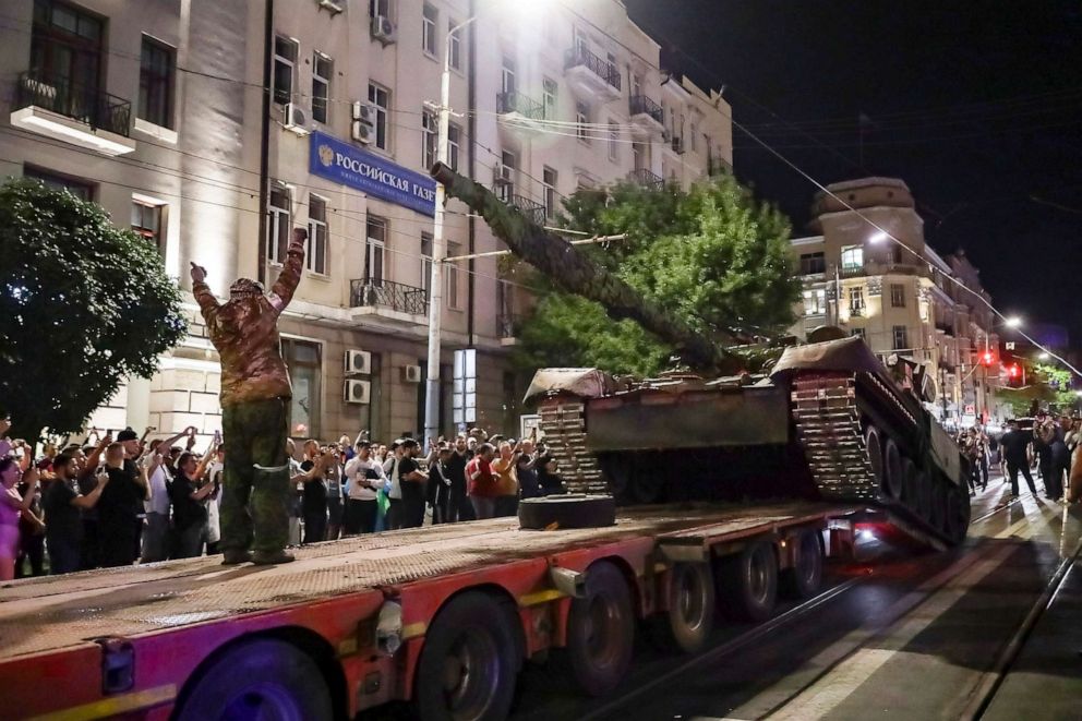 PHOTO: Members of the Wagner Group military company load their tank onto a truck on a street in Rostov-on-Don, Russia, June 24, 2023, prior to leaving an area at the headquarters of the Southern Military District.
