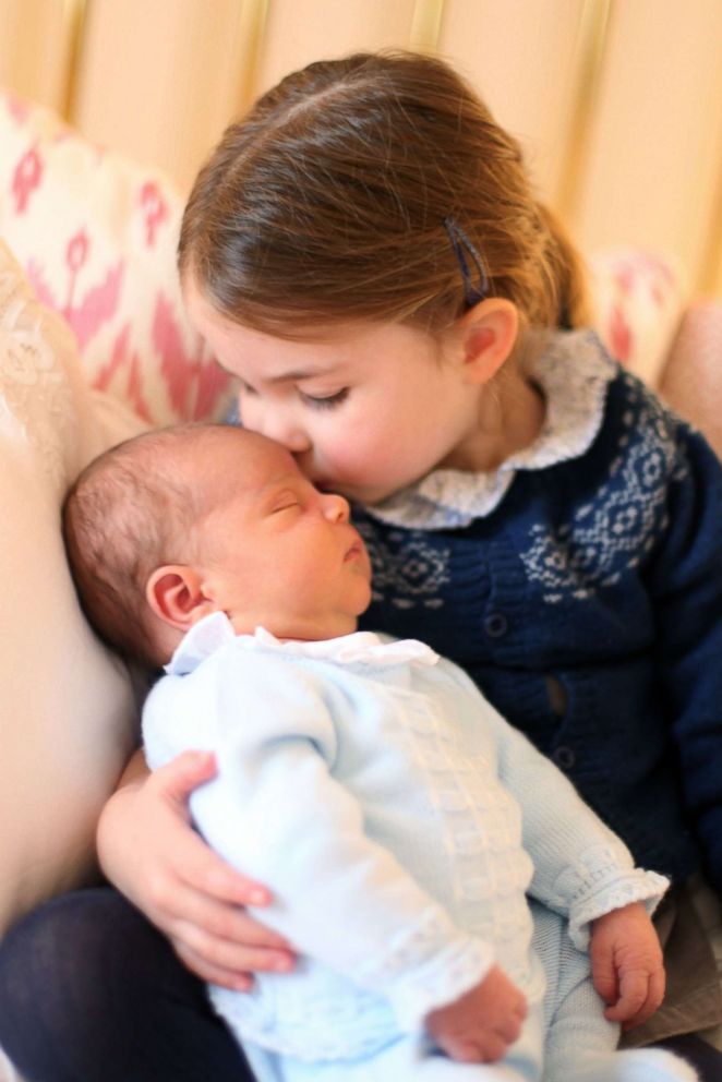 PHOTO:  A photo made available by Kensington Palace on May 5,2018 and taken by Catherine, Duchess of Cambridge shows her daughter Princess Charlotte kissing her brother Prince Louis on her third birthday in London, May 2, 2018.