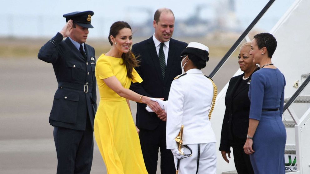 PHOTO: Prince William, Duke of Cambridge and his wife Catherine, Duchess of Cambridge, are greeted by officials upon arrival in Jamaica on March 22, 2022.