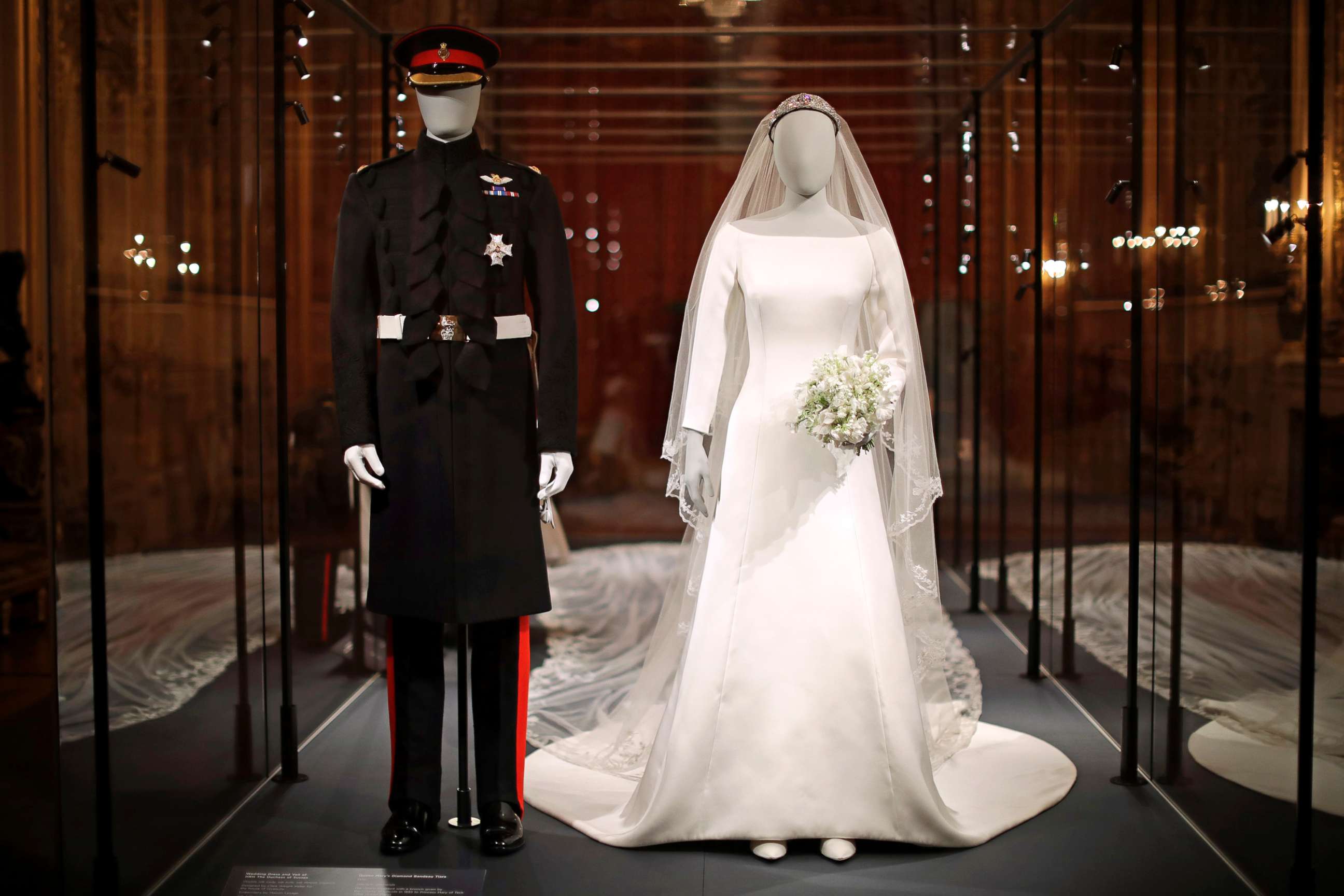 PHOTO: The wedding dress with a five-meter-long veil that Meghan the Duchess of Sussex wore and an identical uniform to the specially commissioned one Prince Harry wore at their May 19, 2018, wedding, are displayed in Windsor, England, Oct. 25, 2018. 