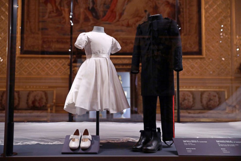 PHOTO: The wedding dress with a five-meter-long veil that Meghan the Duchess of Sussex wore and an identical uniform to the specially commissioned one Prince Harry wore at their May 19, 2018, wedding, are displayed in Windsor, England, Oct. 25, 2018. 