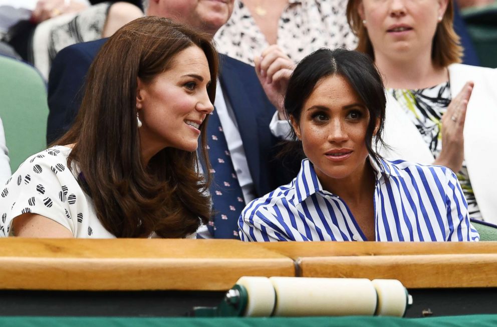PHOTO: Catherine, Duchess of Cambridge and Meghan, Duchess of Sussex attend day twelve of the Wimbledon Lawn Tennis Championships at All England Lawn Tennis and Croquet Club on July 14, 2018 in London.