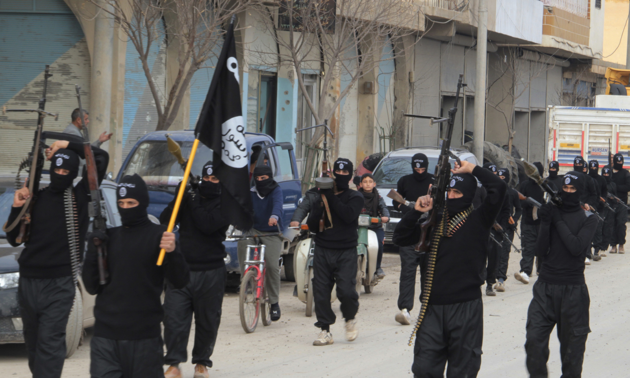 PHOTO: Fighters of al-Qaeda linked Islamic State of Iraq and the Levant carry their weapons during a parade at the Syrian town of Tel Abyad, near the border with Turkey, Jan. 2, 2014. 