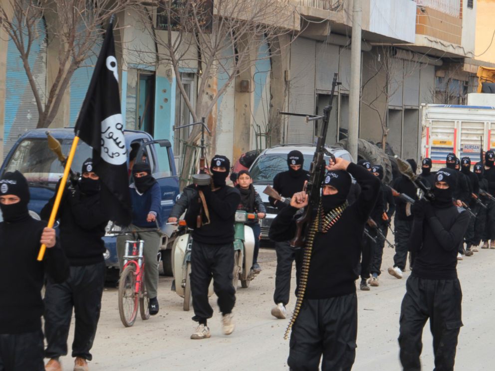 PHOTO: Fighters of al-Qaeda linked Islamic State of Iraq and the Levant carry their weapons during a parade at the Syrian town of Tel Abyad, near the border with Turkey, Jan. 2, 2014.