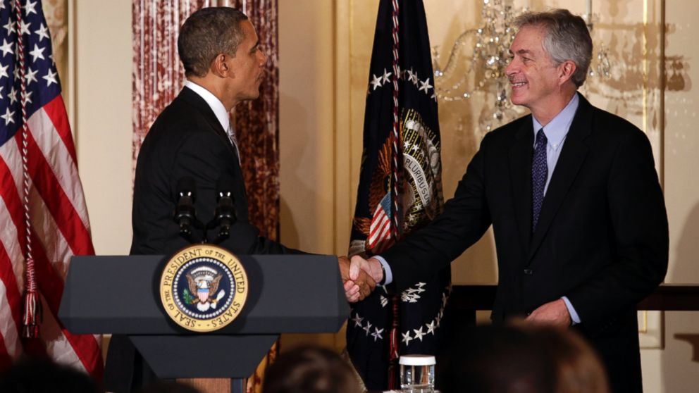 U.S. President Barack Obama shakes hands with Deputy Secretary of State William Burns at the Diplomatic Corps holiday reception at the State Department in Washington, Dec. 19, 2012.