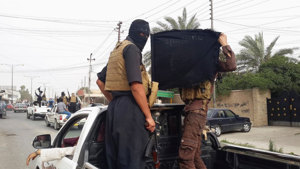 PHOTO: Fighters of the Islamic State of Iraq and the Levant (ISIL) celebrate on vehicles taken from Iraqi security forces, at a street in city of Mosul, June 12, 2014.