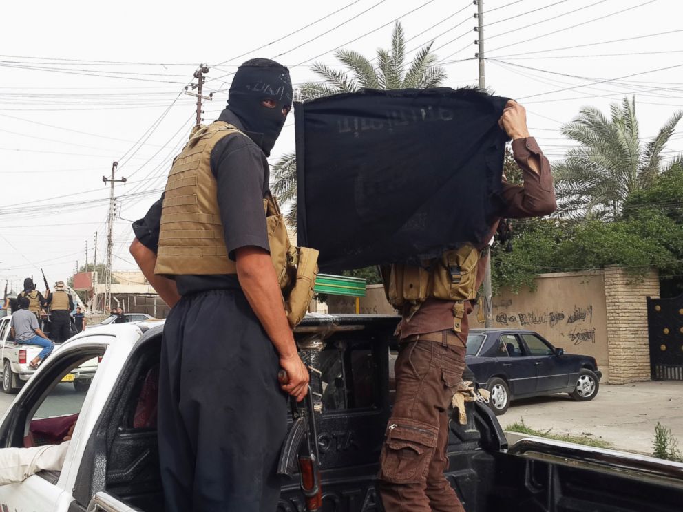 PHOTO: Fighters of the Islamic State of Iraq and the Levant (ISIL) celebrate on vehicles taken from Iraqi security forces, at a street in city of Mosul, June 12, 2014.
