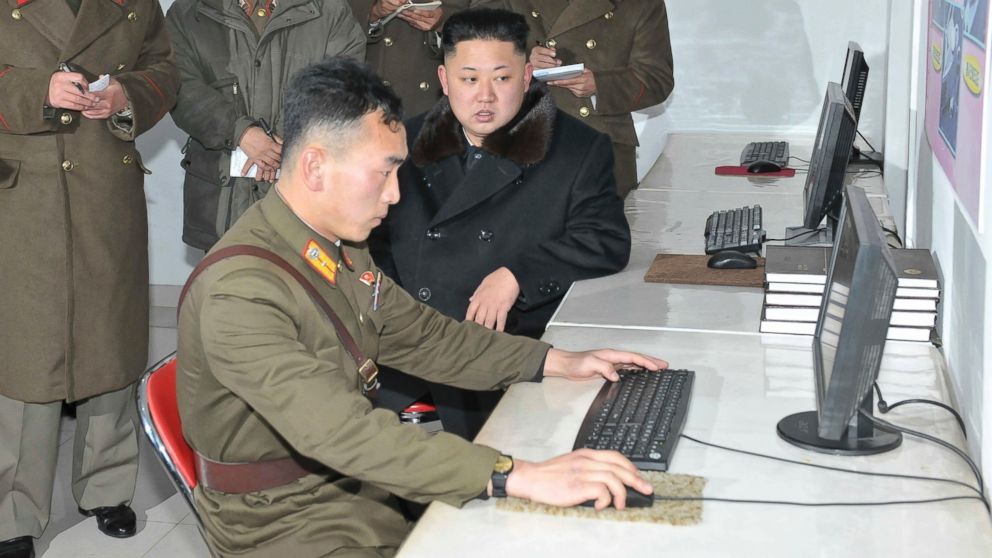 North Korean leader Kim Jong Un, center, visits the Designing Institute of the Korean People's Army, in this undated photo released by North Korea's Korean Central News Agency (KCNA) in Pyongyang, Dec. 14, 2013. 