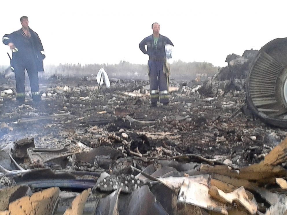 PHOTO: Emergencies Ministry members work at the site of a Malaysia Airlines Boeing 777 plane crash in the settlement of Grabovo in the Donetsk region, July 17, 2014. 