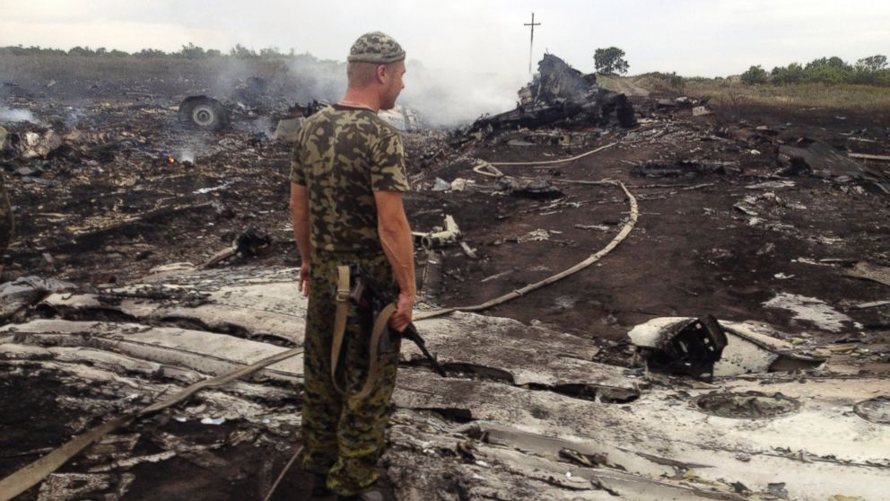 An armed pro-Russian separatist stands at a site of a Malaysia Airlines Boeing 777 plane crash in the settlement of Grabovo in the Donetsk region, July 17, 2014.
