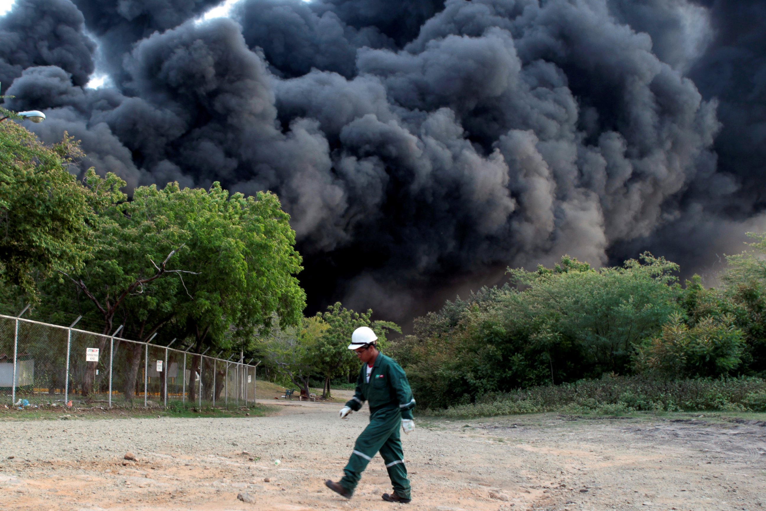 PHOTO: Black smoke billows following an explosion caused by a fire at a fuel storage tank belonging to the Puma Energy company in Puerto Sandino, Leon, Nicaragua, August 18, 2016. 