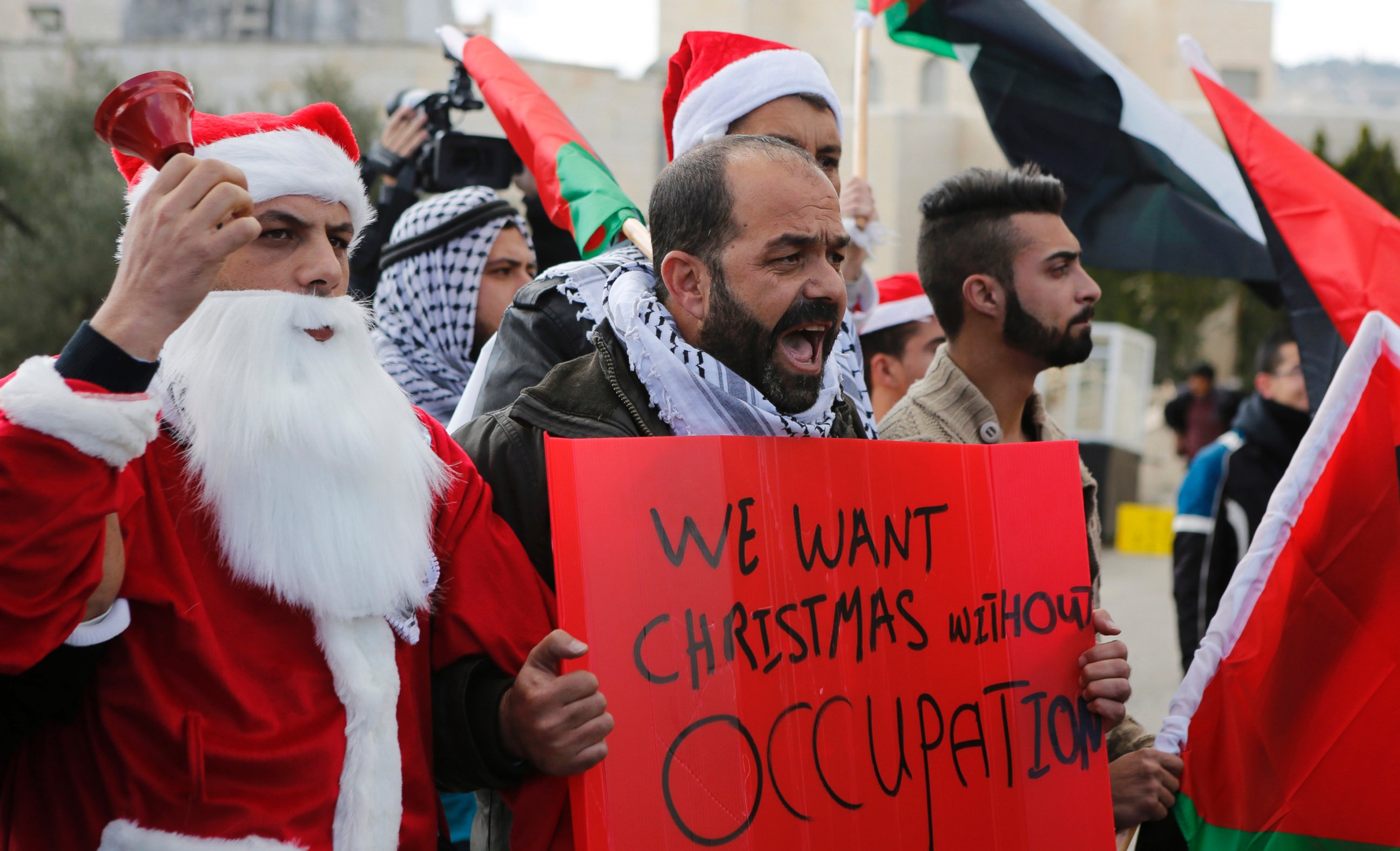 PHOTO: A Palestinian protestors demonstrate against Israeli settlements during Christmas, near a checkpoint in the West Bank city of Bethlehem, Dec. 23, 2014. 