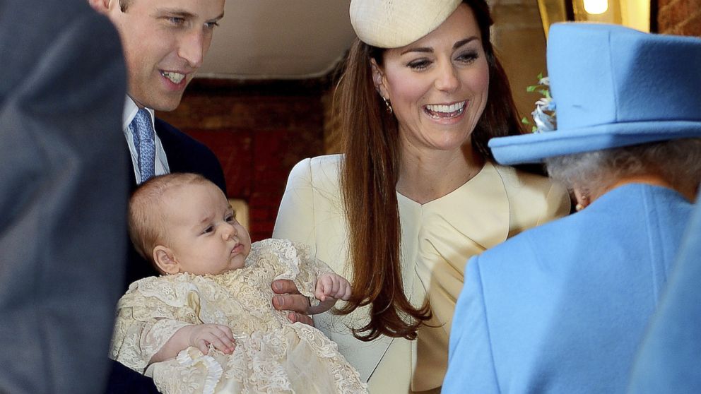 Britain's Prince William carries his son Prince George, as he arrives with Kate, Duchess of Cambridge, for their son's christening at St James's Palace in London, Oct. 23, 2013.