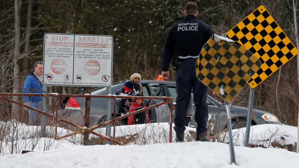 PHOTO: A woman who told police that she and her family were from Sudan is confronted by Royal Canadian Mounted Police officer as she arrives by taxi and attempts to walk across the U.S.-Canada border into Hemmingford, Quebec, Feb. 12, 2017.