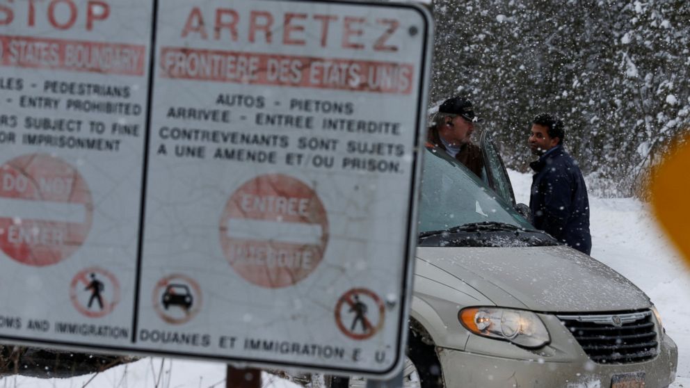PHOTO: A man who told police he was from Sudan talks to his taxi driver after being told by Royal Canadian Mounted Police officers to go to the Lacolle border, at a U.S.-Canada border into Hemmingford, Quebec, Feb. 13, 2017.