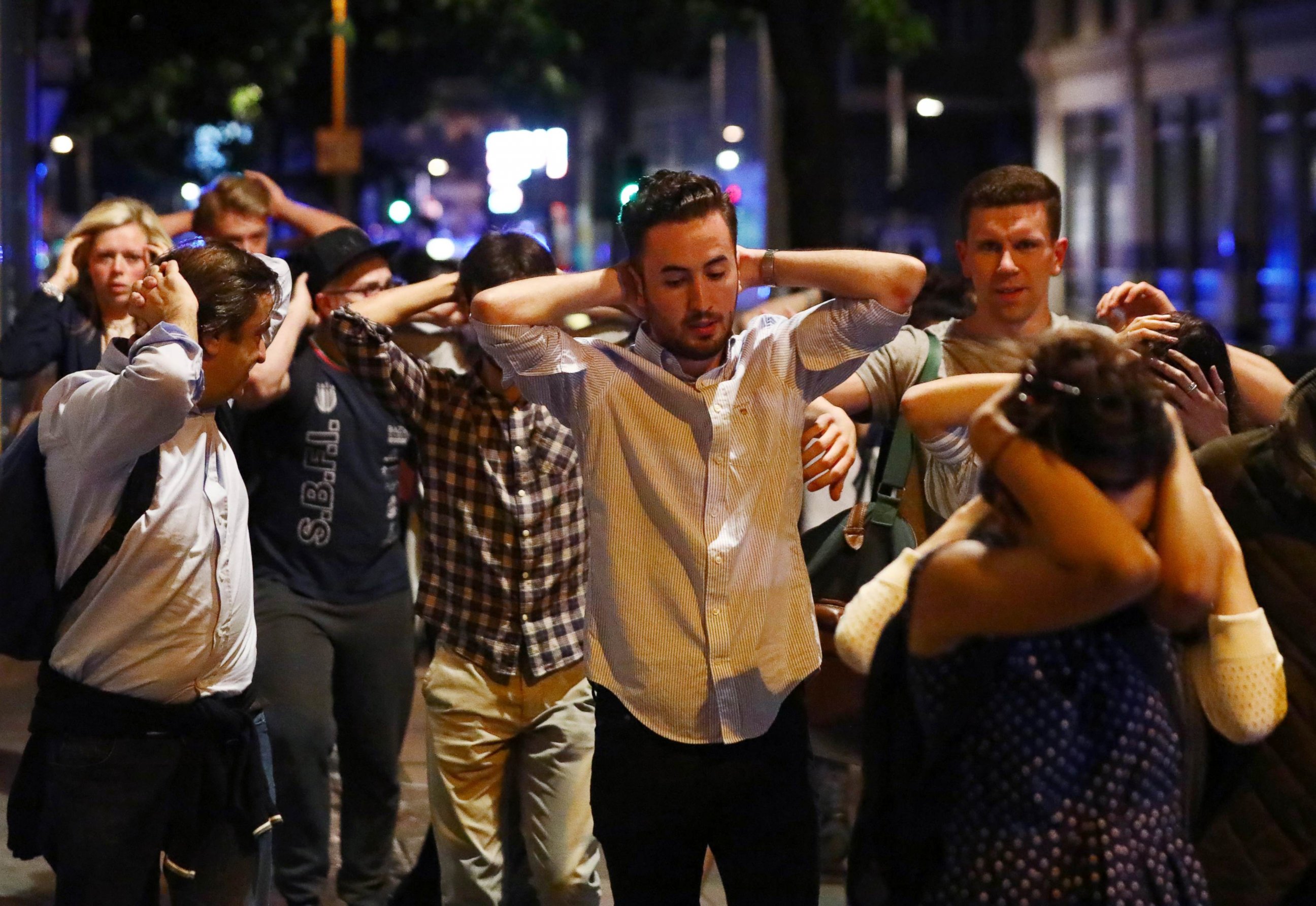 PHOTO: People leave the area with their hands up after an incident near London Bridge in London, June 4, 2017.