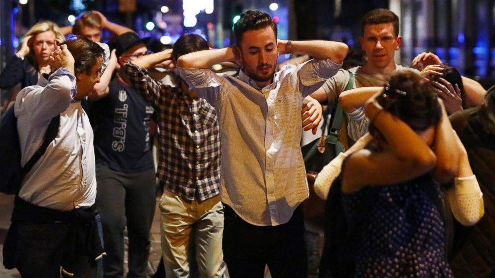 PHOTO: People leave the area with their hands up after an incident near London Bridge in London, June 4, 2017.