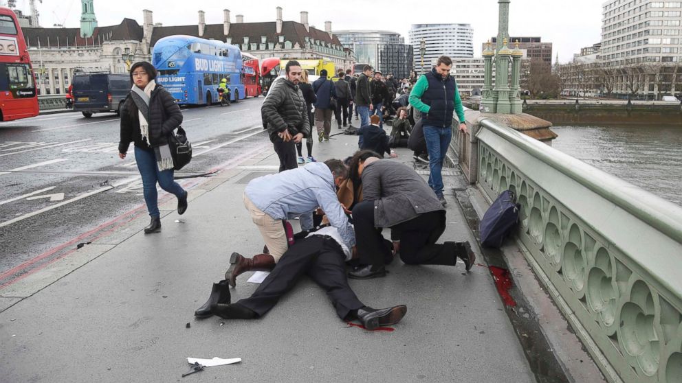 Injured people are assisted after an incident on Westminster Bridge in London, March 22, 2017.