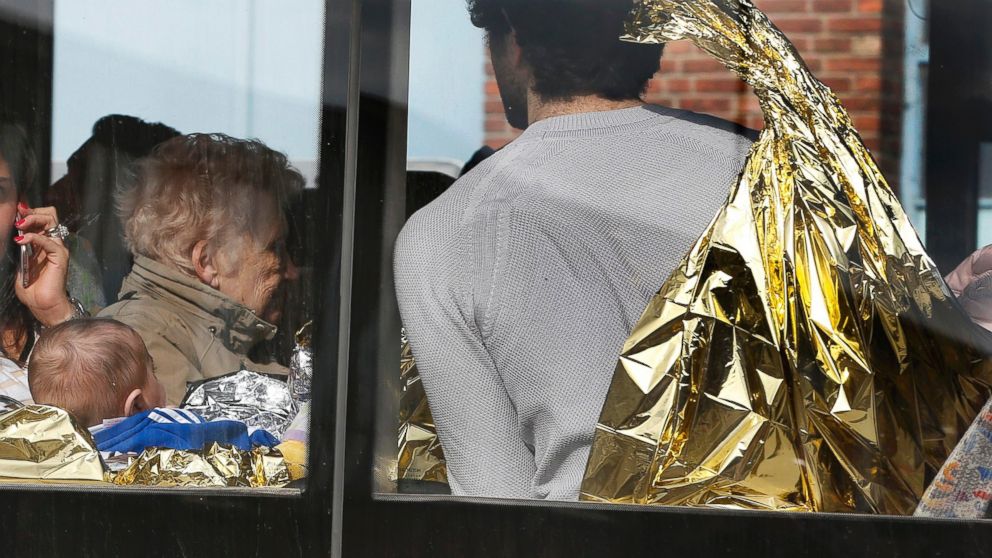 PHOTO: People in thermal blankets are driven from the scene of explosions at Zaventem airport near Brussels, Belgium, March 22, 2016.