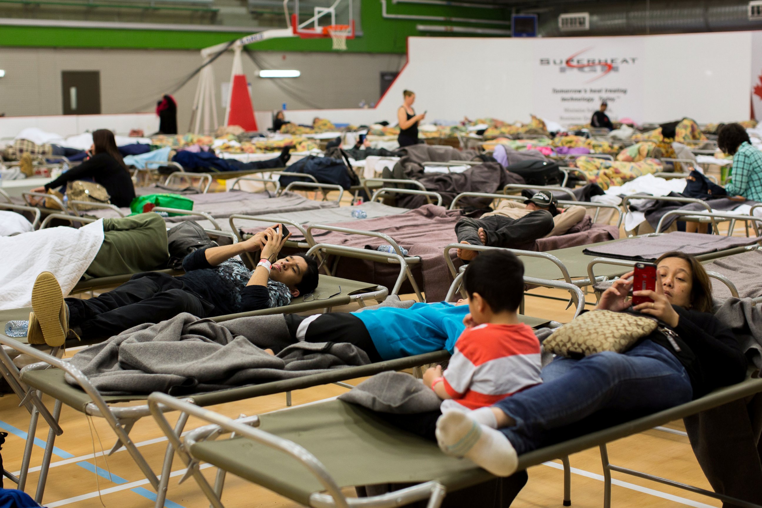 PHOTO: Fort McMurray residents rest at a community centre in Anzac, Alberta, after residents were ordered to be evacuated due to a raging wildfire, May 4, 2016.