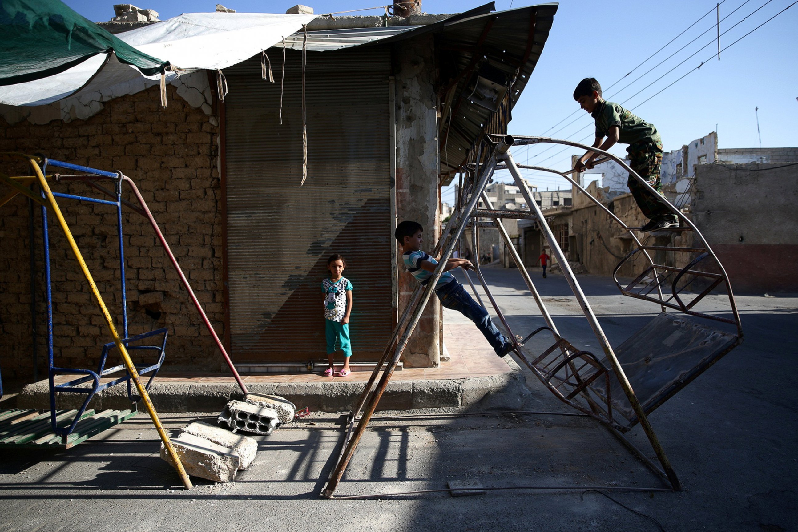 PHOTO: Children play on swings on the first day of the Muslim holiday of Eid al-Fitr, which marks the end of the holy month of Ramadan, in the rebel held Douma neighborhood of Damascus, Syria July 6, 2016.