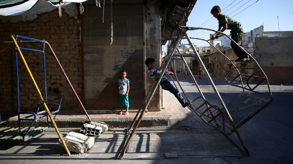 PHOTO: Children play on swings on the first day of the Muslim holiday of Eid al-Fitr, which marks the end of the holy month of Ramadan, in the rebel held Douma neighborhood of Damascus, Syria July 6, 2016.