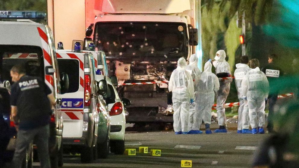 PHOTO: French police forces and forensic officers stand next to a truck that ran into a crowd in Nice, France, July 14, 2016.