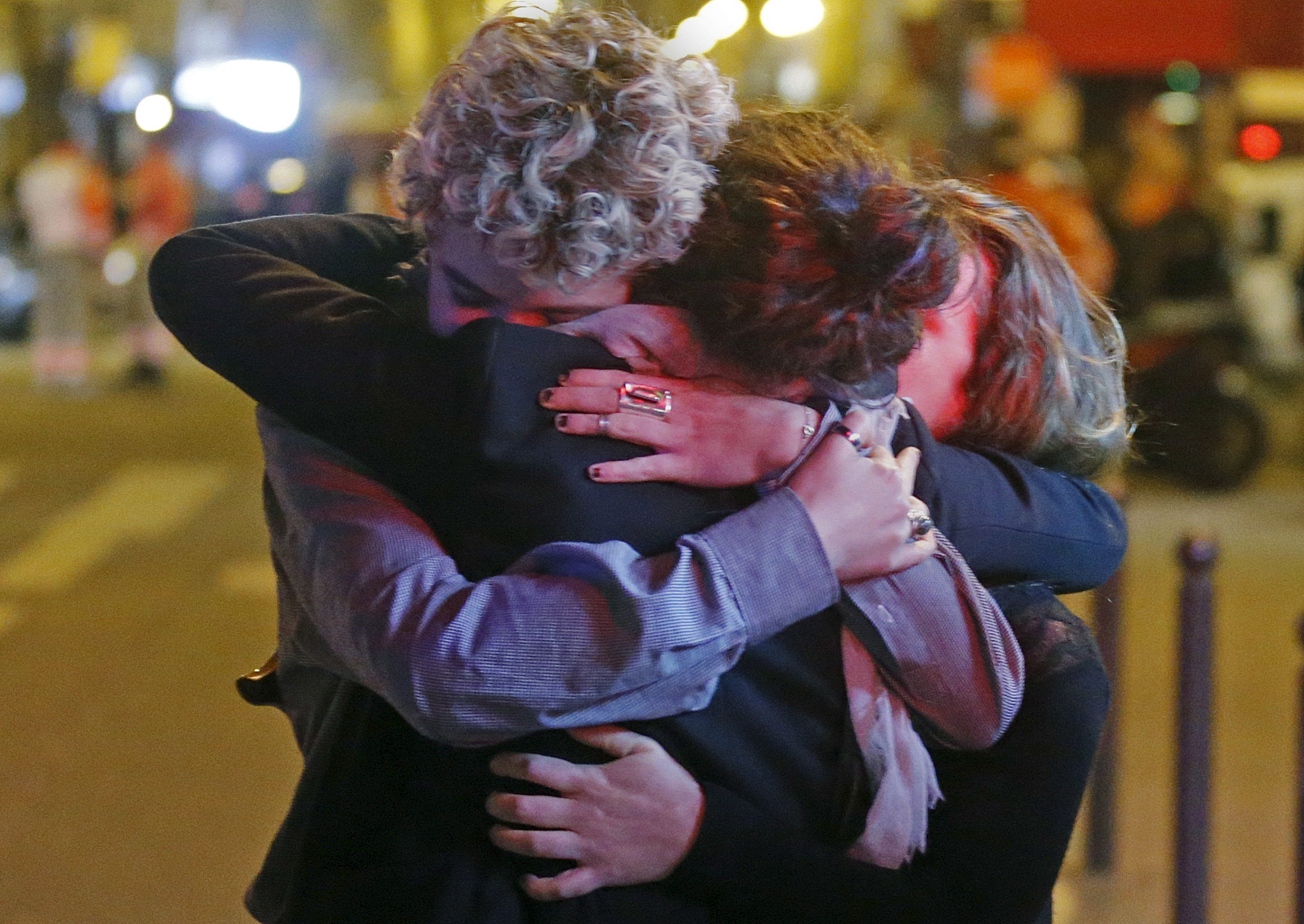 PHOTO: People hug on the street near the Bataclan concert hall following fatal attacks in Paris, Nov. 14, 2015.