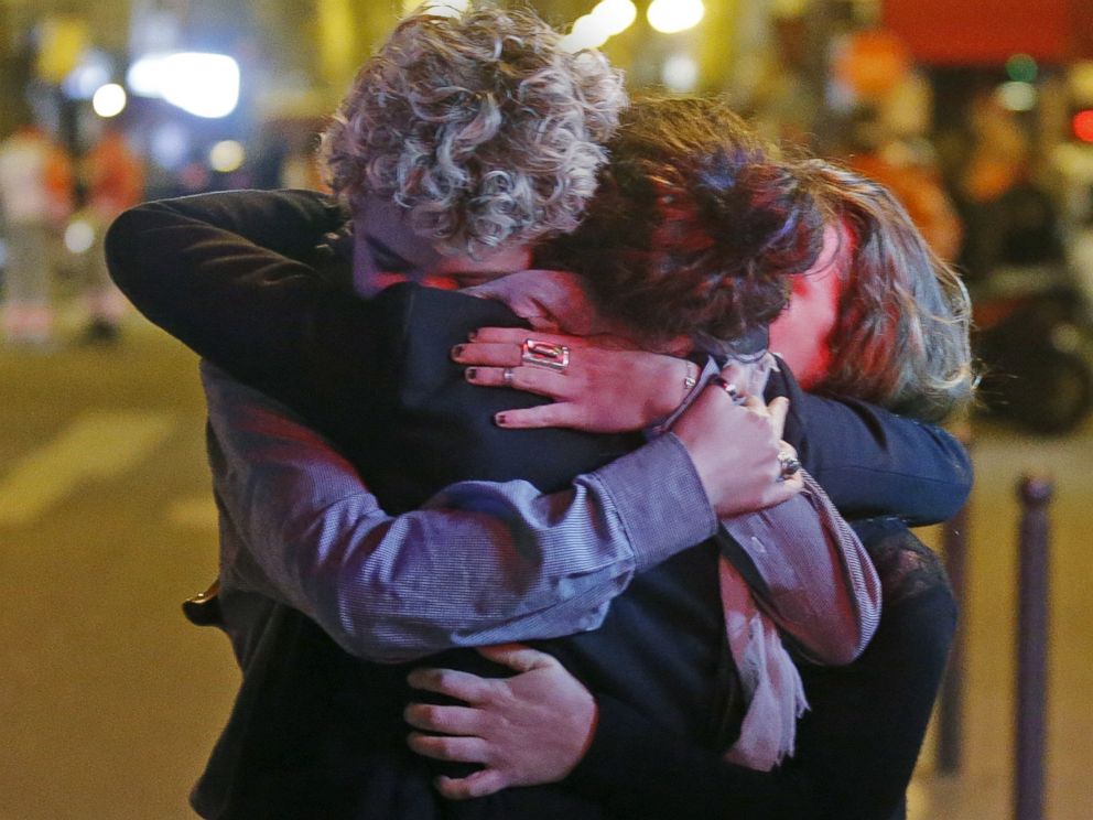 PHOTO: People hug on the street near the Bataclan concert hall following fatal attacks in Paris, Nov. 14, 2015.