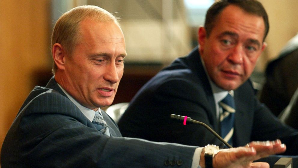 Russian President Vladimir Putin gestures as Mass Media Minister
Mikhail Lesin listens to him during a meeting with local press in the
far eastern city of Vladivostok, August 24, 2002.