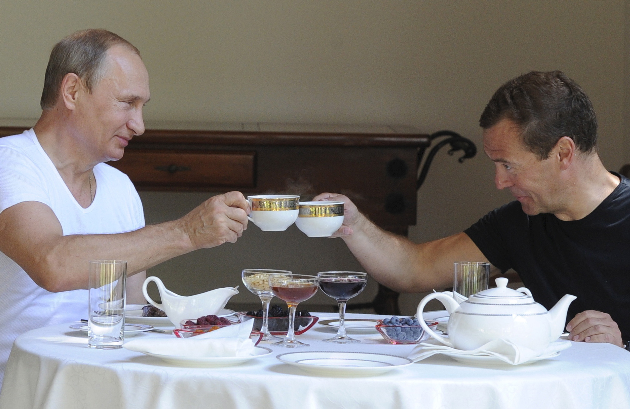 PHOTO: Russian President Vladimir Putin and Prime Minister Dmitry Medvedev toast with tea cups during breakfast at the Bocharov Ruchei state residence in Sochi, Russia, Aug. 30, 2015.