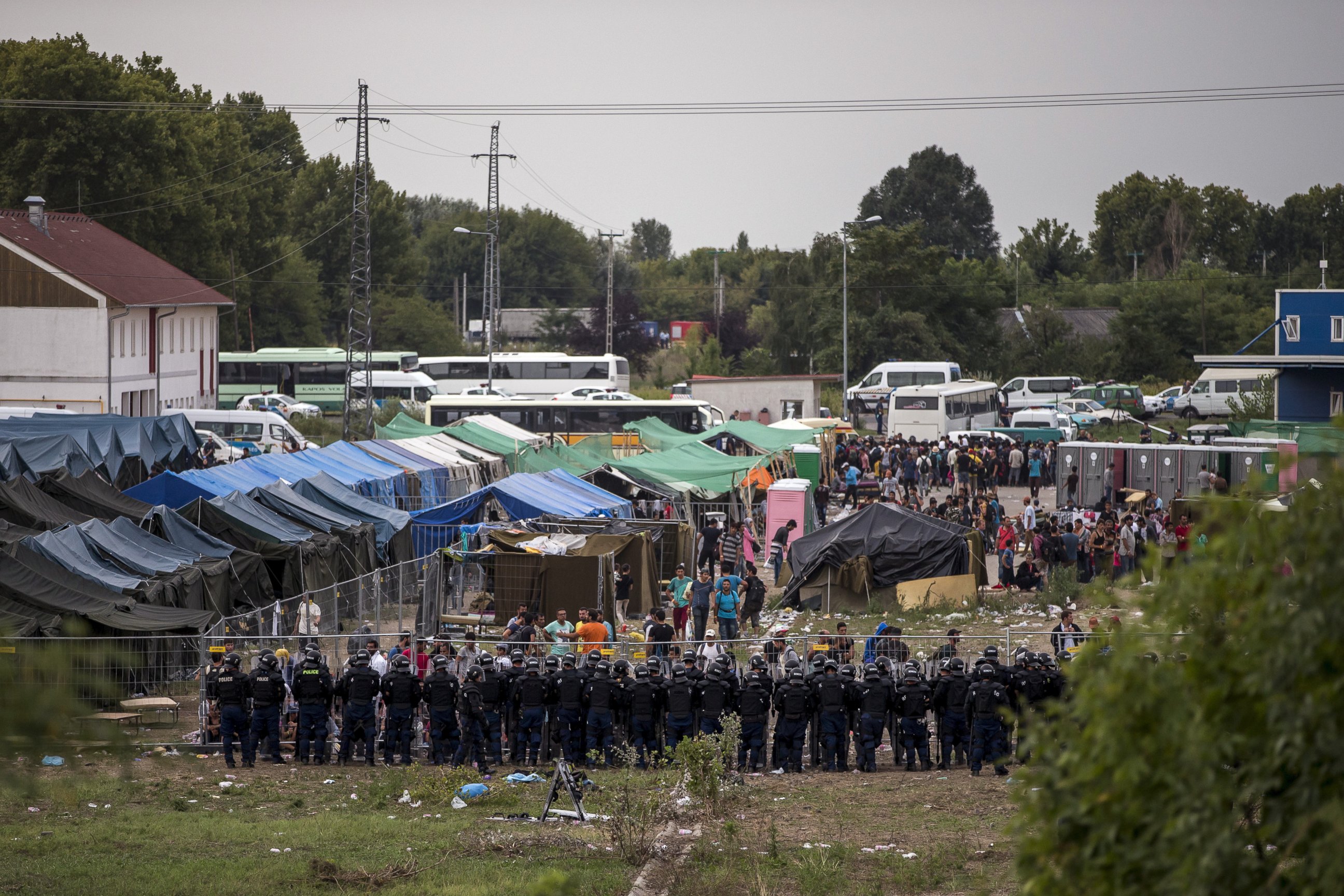 PHOTO: Riot police stand guard in front of a migrant reception centre in Roszke, Hungary, Sept. 4, 2015.