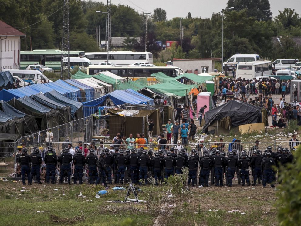 PHOTO: Riot police stand guard in front of a migrant reception centre in Roszke, Hungary, Sept. 4, 2015.