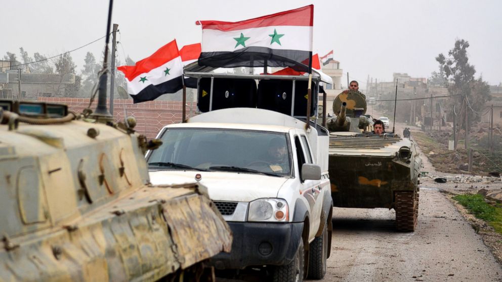 Fighters loyal to Syria's President Bashar Al-Assad ride on military vehicles and tanks after regaining control of Deir al-Adas, a town south of Damascus, on Feb. 10, 2015.