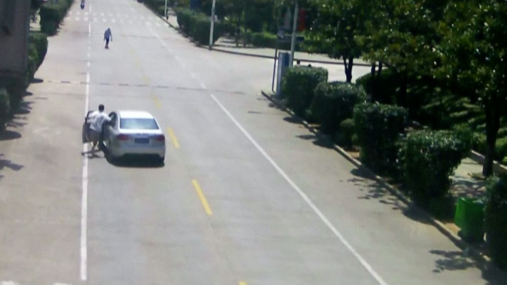 PHOTO: Taxi driver Hu Wengang is seen on surveillance video leaping into an out-of-control vehicle before bringing it to a stop in central China's Hubei province on Saturday, July 20, 2019.