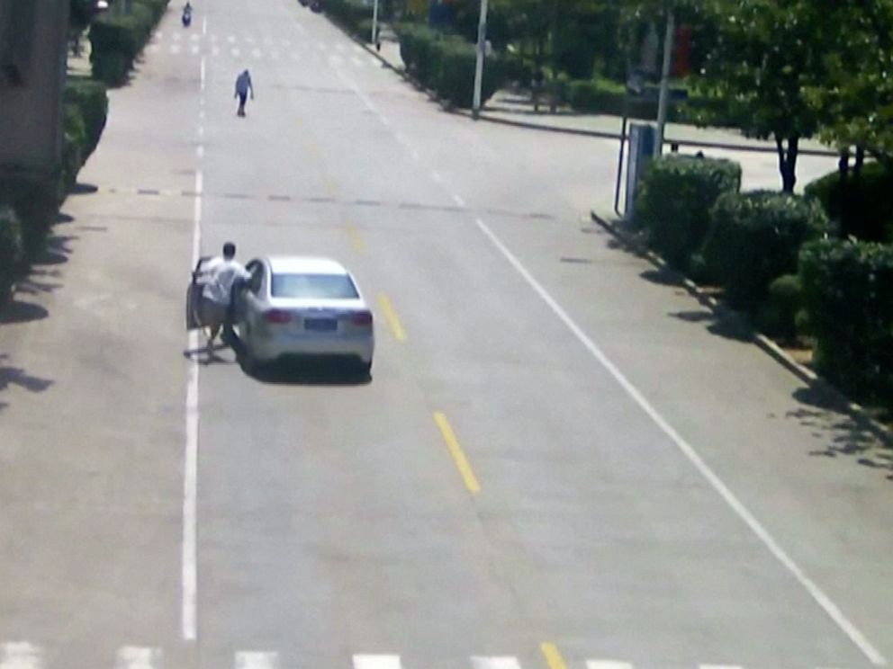 PHOTO: Taxi driver Hu Wengang is seen on surveillance video leaping into an out-of-control vehicle before bringing it to a stop in central Chinas Hubei province on Saturday, July 20, 2019.