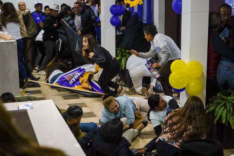 PHOTO: Supporters of presidential candidate Fernando Villavicencio run for cover after he was shot to death while at a campaign rally outside a school in Quito, Ecuador, Wednesday, Aug. 9, 2023.