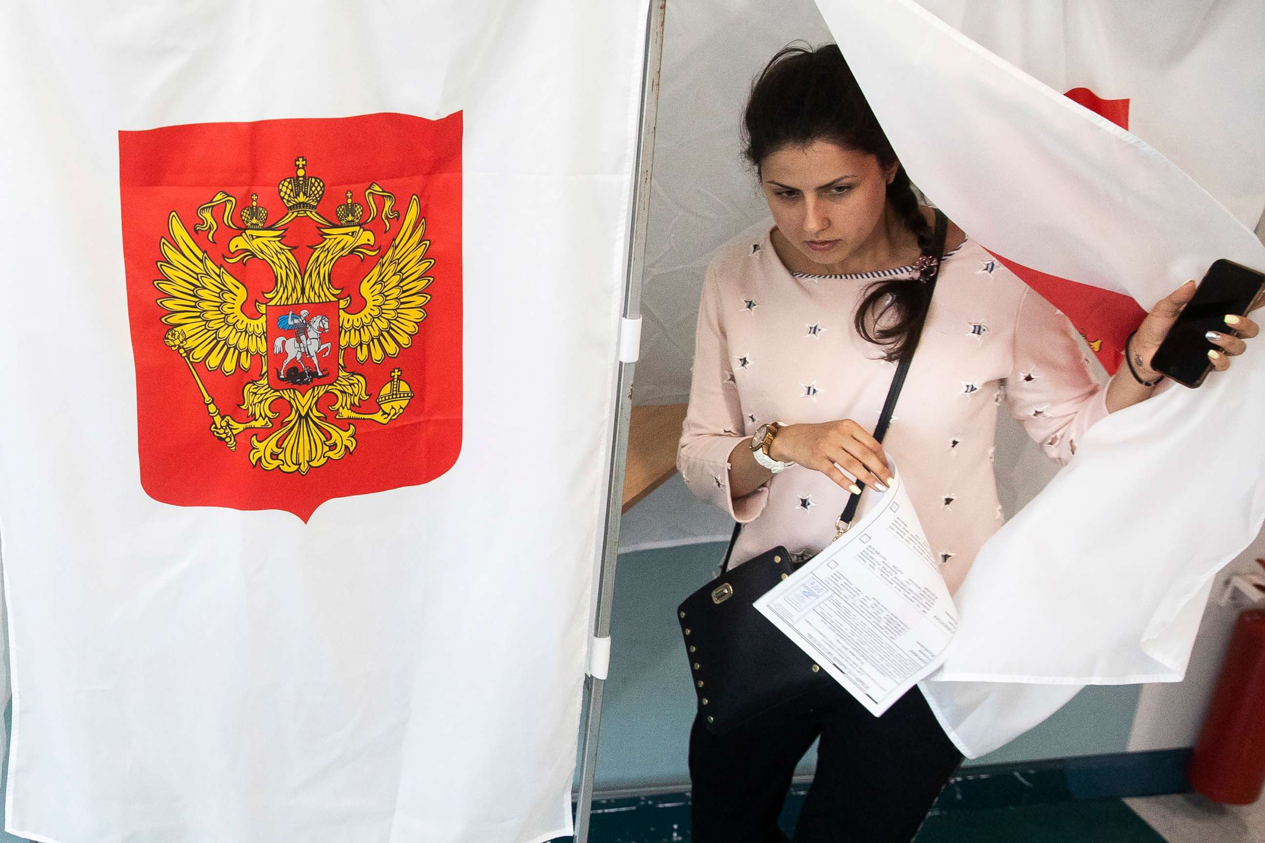 PHOTO: A woman exits a polling booth before casting at a polling station during a city council election in Moscow, Sept. 8, 2019. 