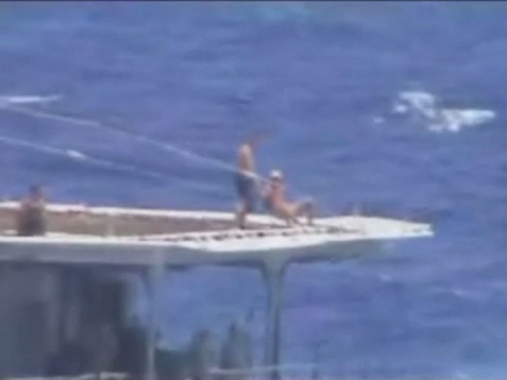 PHOTO: A screen grab from U.S. Navy video shows what appears to be Russian sailors sunbathing on the destroyers helicopter pad.