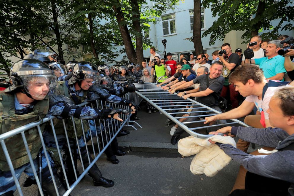 PHOTO:Demonstrators attempt to remove fences during a rally calling for opposition candidates to be registered for elections to Moscow City Duma, the capital's regional parliament, in Moscow, July 27, 2019. 