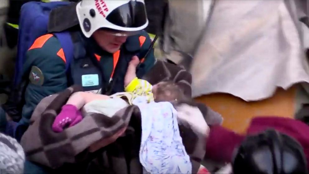 PHOTO: A rescuer carries a baby found alive in the rubble of a Russian apartment block that partially collapsed after a suspected gas blast in Magnitogorsk, Russia, Jan. 1, 2019.