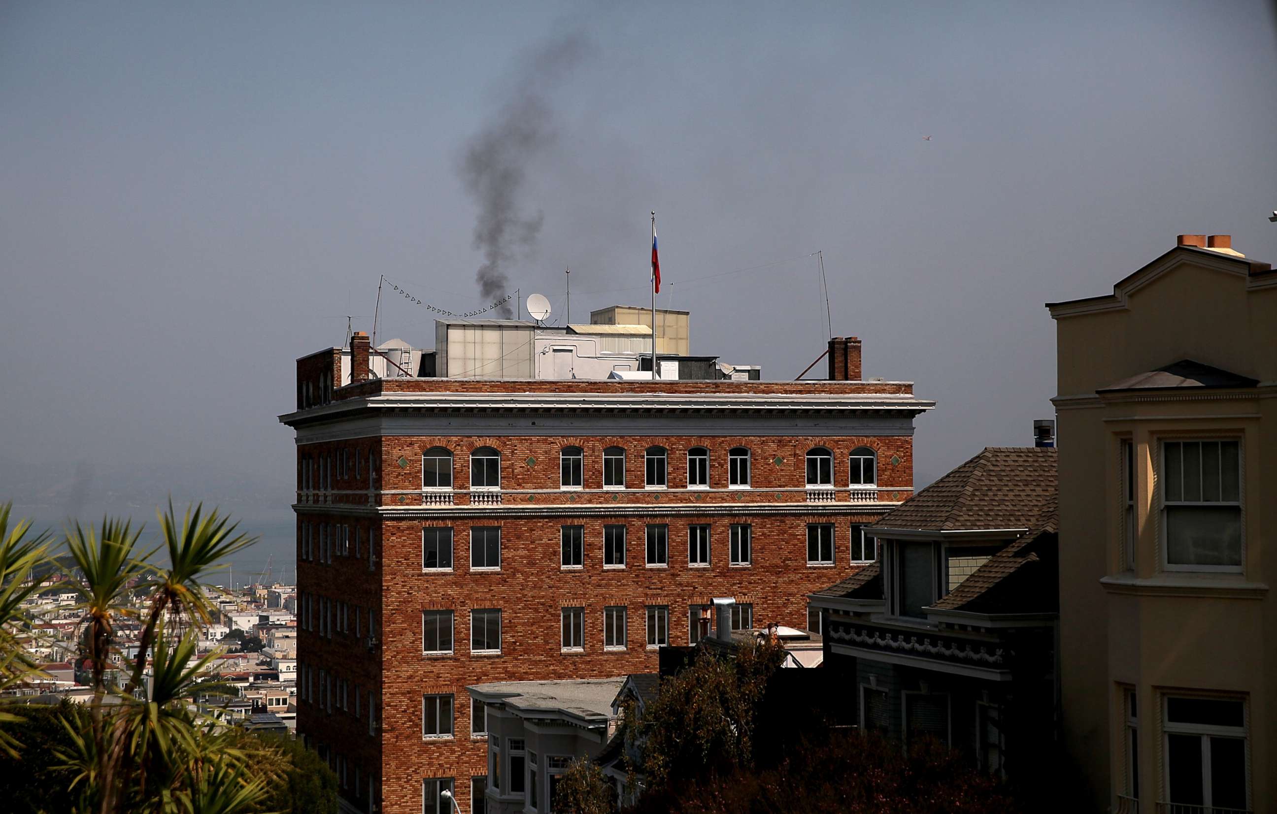 PHOTO: Black smoke billows from a chimney on top of the Russian consulate, Sept. 1, 2017 in San Francisco. 