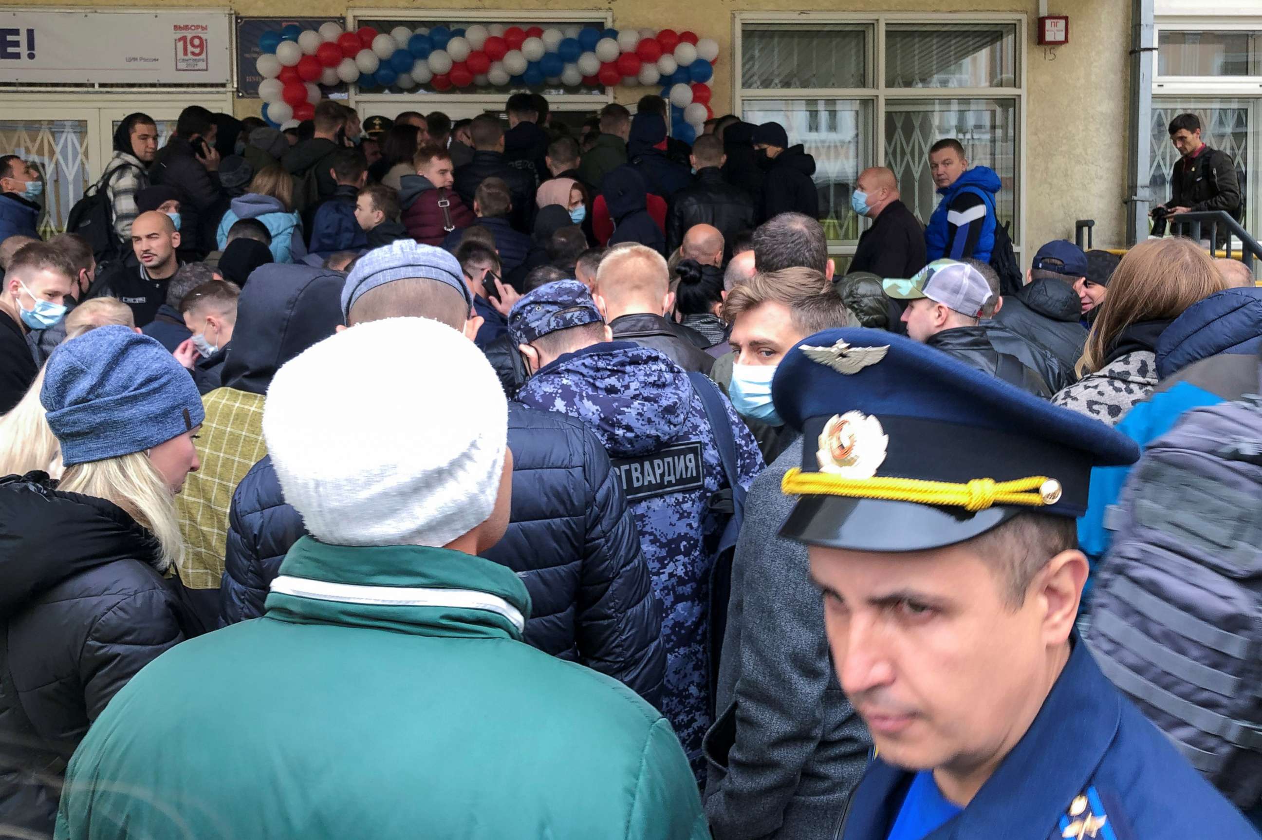PHOTO: Voters, including Russian service members, queue before entering a polling station during a three-day parliamentary election in Moscow, Sept. 17, 2021.