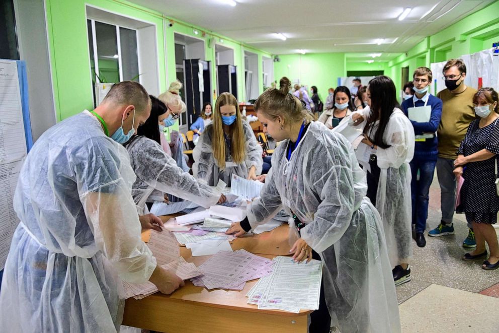 PHOTO: Members of a local election commission empty ballot boxes and sort ballots for the further counting on Sunday on the first day of the three-day parliamentary election in the far eastern city of Vladivostok, Sept. 17, 2021.