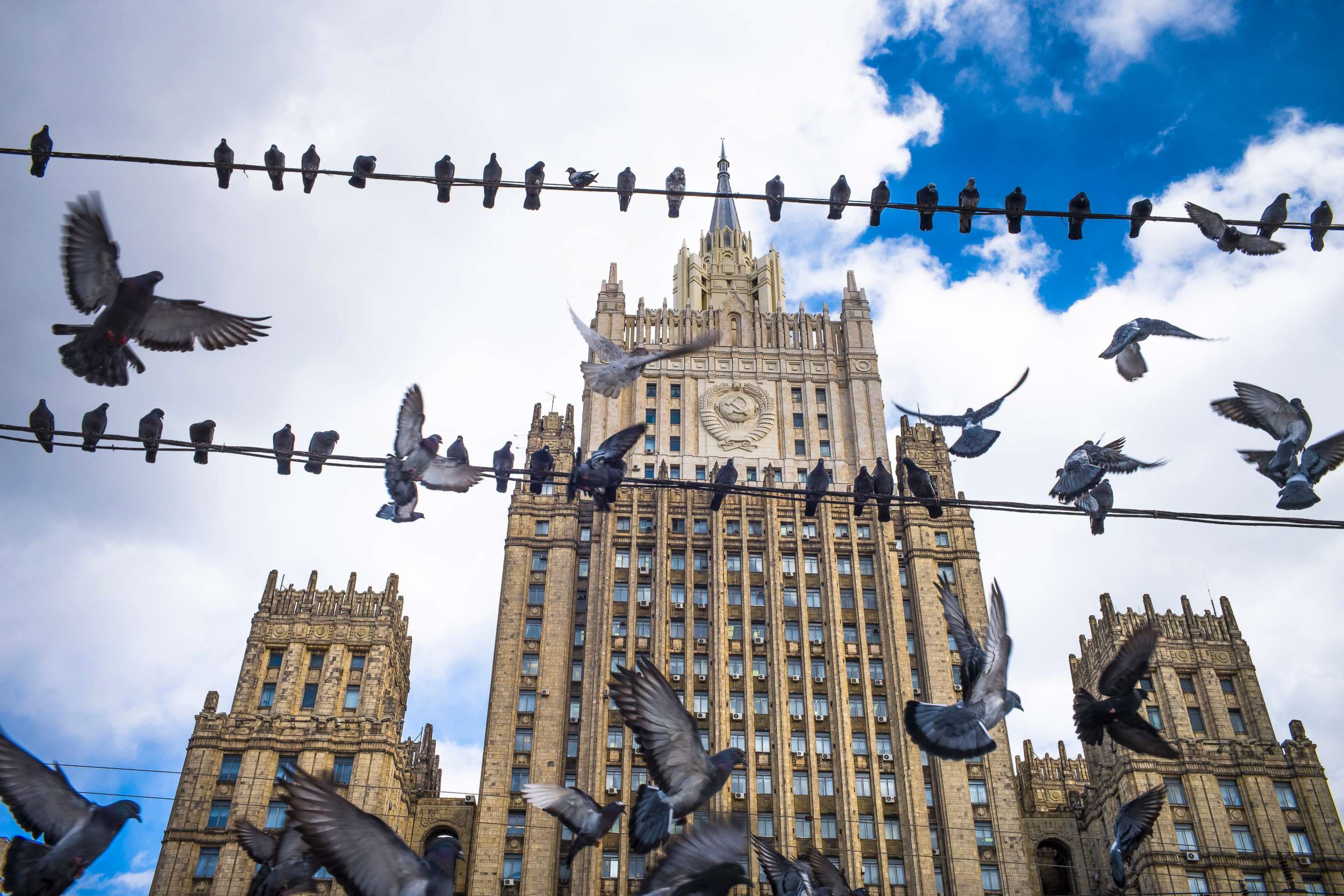 PHOTO: Pigeons take off from wires in front of the Russian Foreign Ministry building, in Moscow, Russia, March 29, 2018.