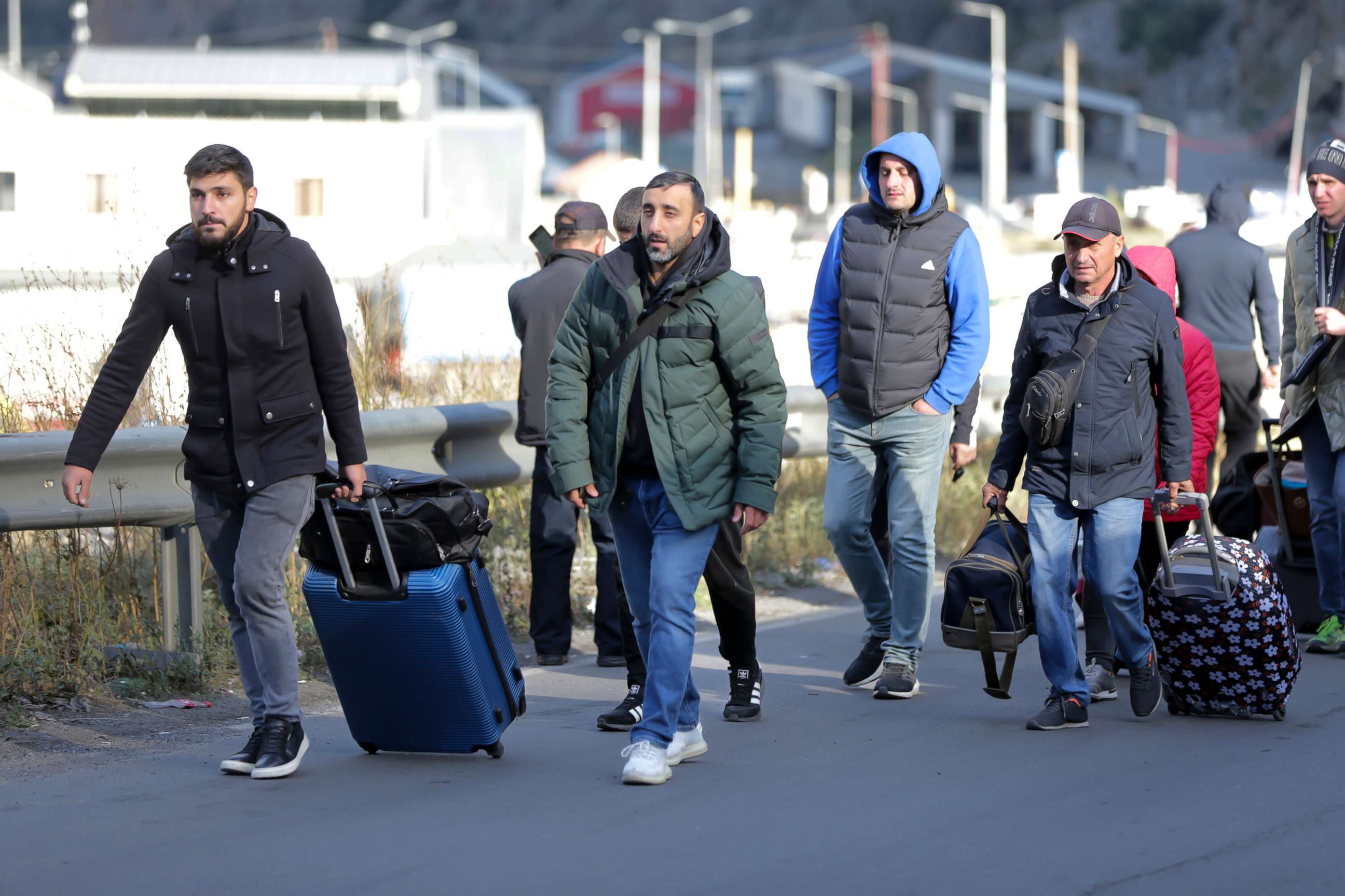 PHOTO: A group of Russians walk after crossing the border at Verkhny Lars between Georgia and Russia in Georgia, on Sept. 27, 2022.