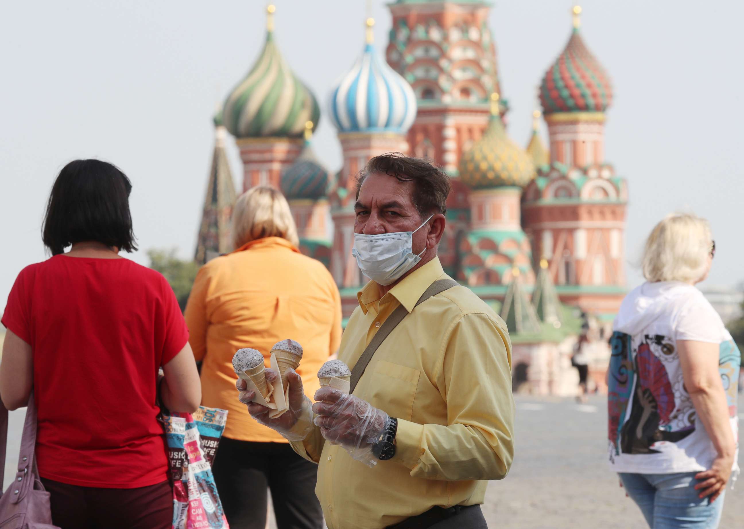 PHOTO: A man eats ice cream in Red Square with St. Basil's Cathedral in the background, in Moscow, June 23, 2021, in a photo released by Russian government owned media.