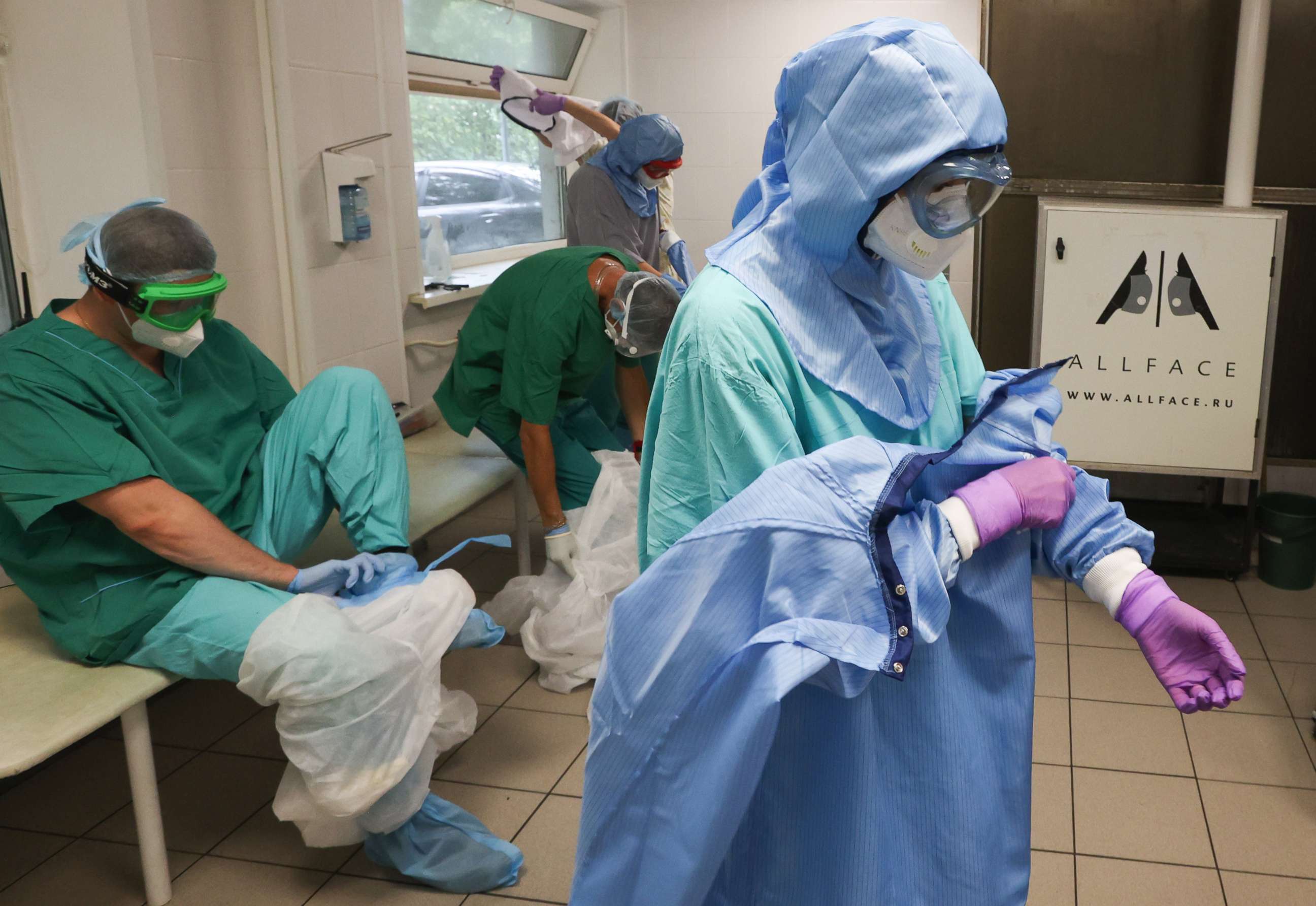 PHOTO: Medical workers take off their protective suits after working in the red zone at City Clinical Hospital No 15 (Filatov Hospital) in Moscow, Russia, July 19, 2021.